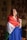 woman in blue white and red long sleeve shirt holding white and red flag