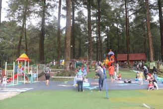 Cartoon kids happily playing on safe playground equipment under supervision.