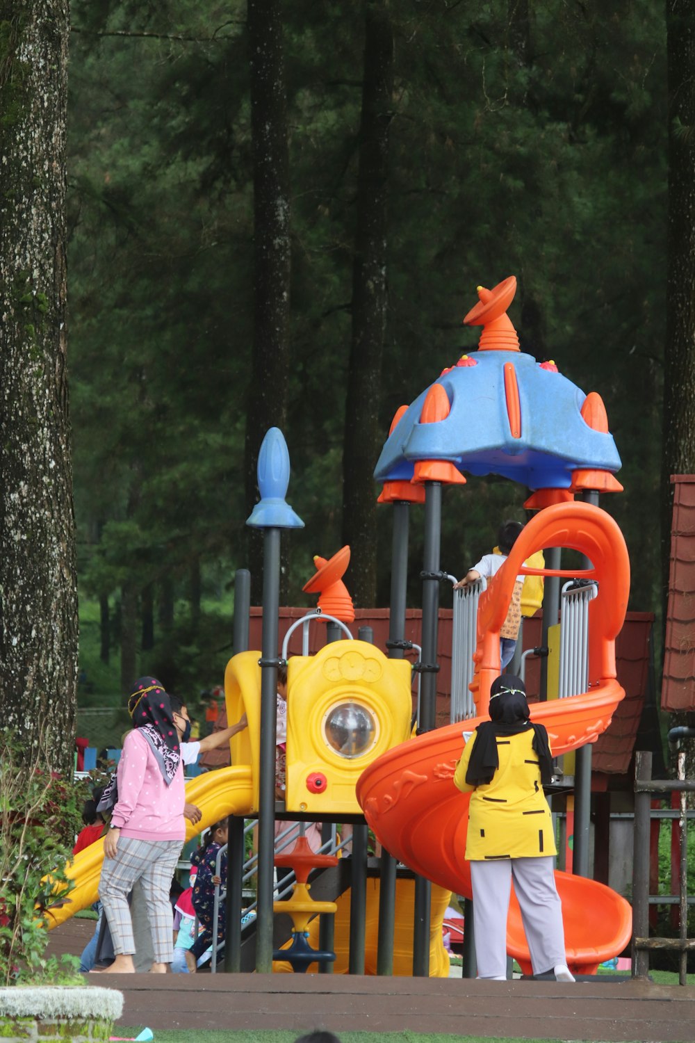 people riding yellow and red roller coaster during daytime