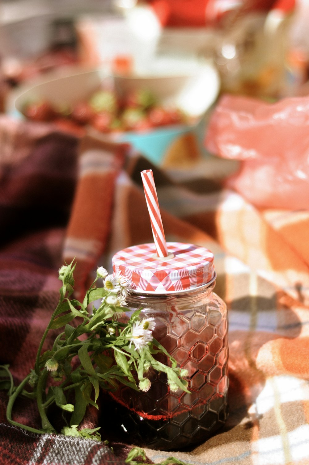 clear glass jar with red and white stripe straw