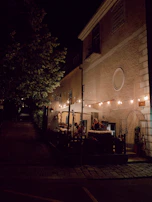 Outdoor seating area with string lights creating a warm evening ambiance.