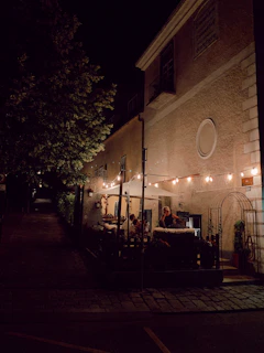 Outdoor seating area with string lights creating a warm evening ambiance.