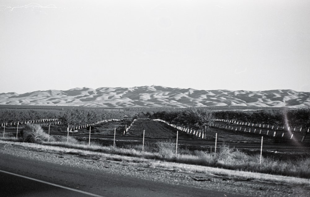 gray asphalt road near snow covered mountain during daytime