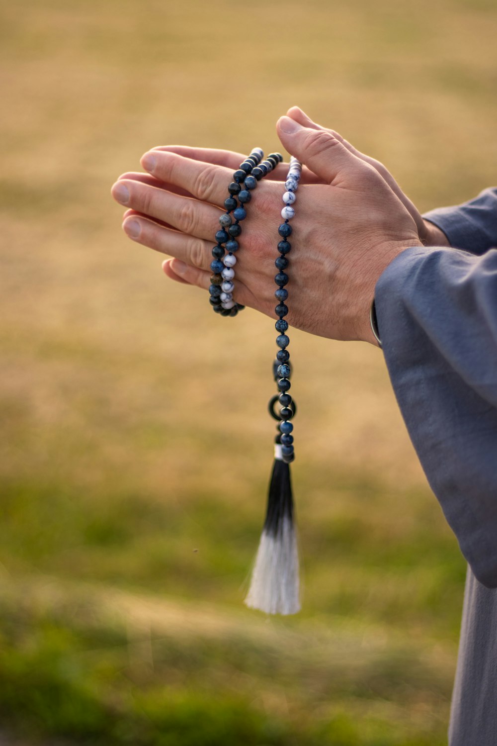 person wearing silver and black beaded bracelet