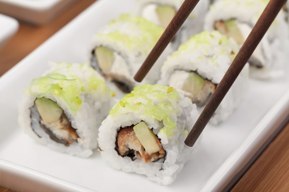 white and green sushi on white ceramic plate