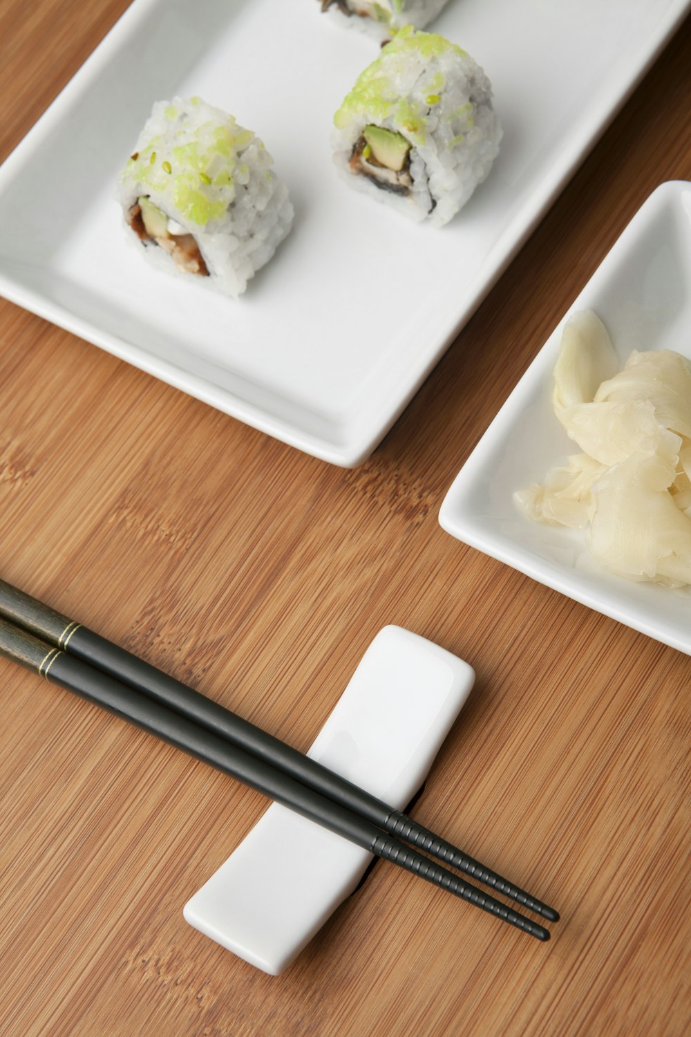 white ceramic plate with black chopsticks