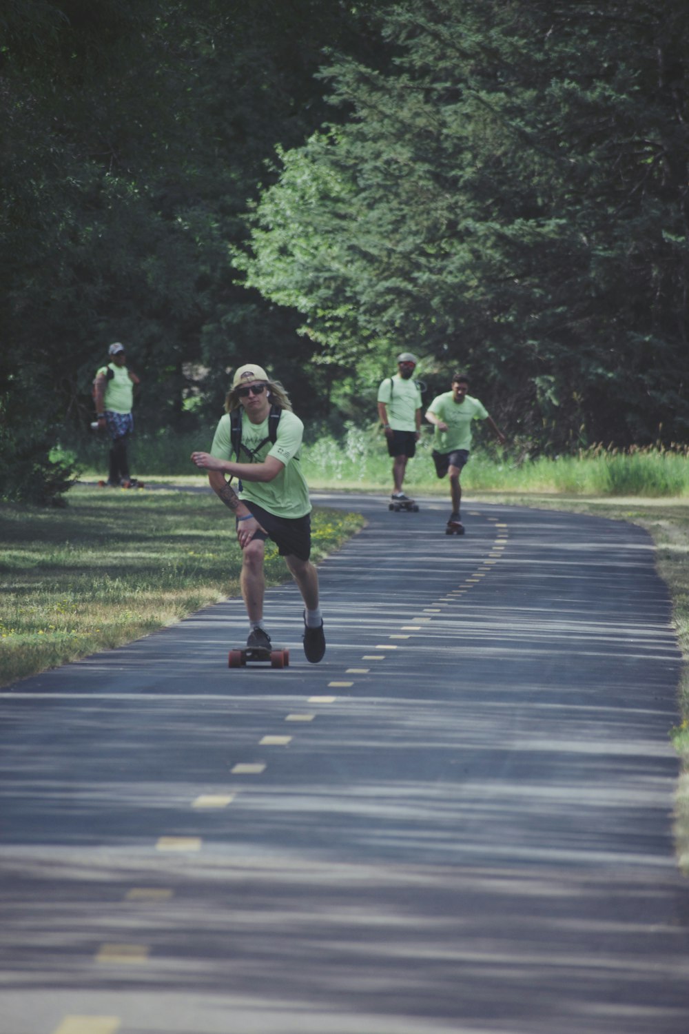 3 women running on gray asphalt road during daytime
