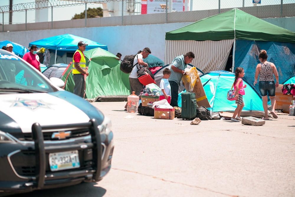 people standing near green tent during daytime