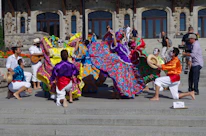 Traditional dancers in vibrant costumes performing during a festival in Burkina Faso.