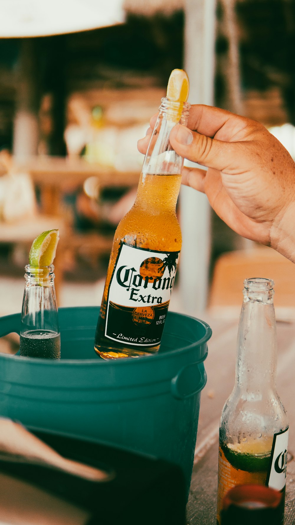 clear glass bottle on green plastic bucket