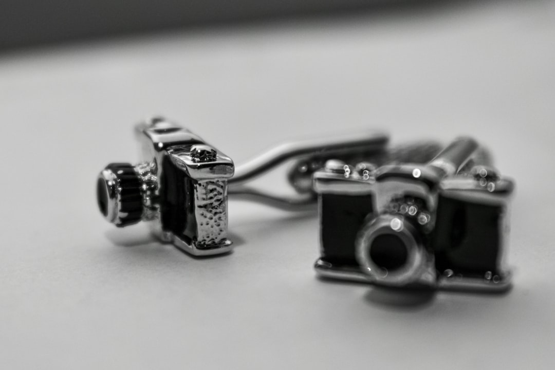 silver and black camera on white table,
