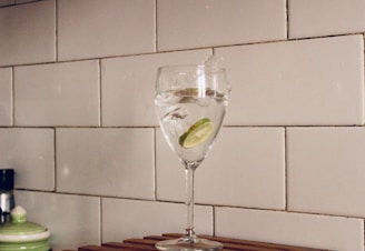 clear wine glass with green liquid inside