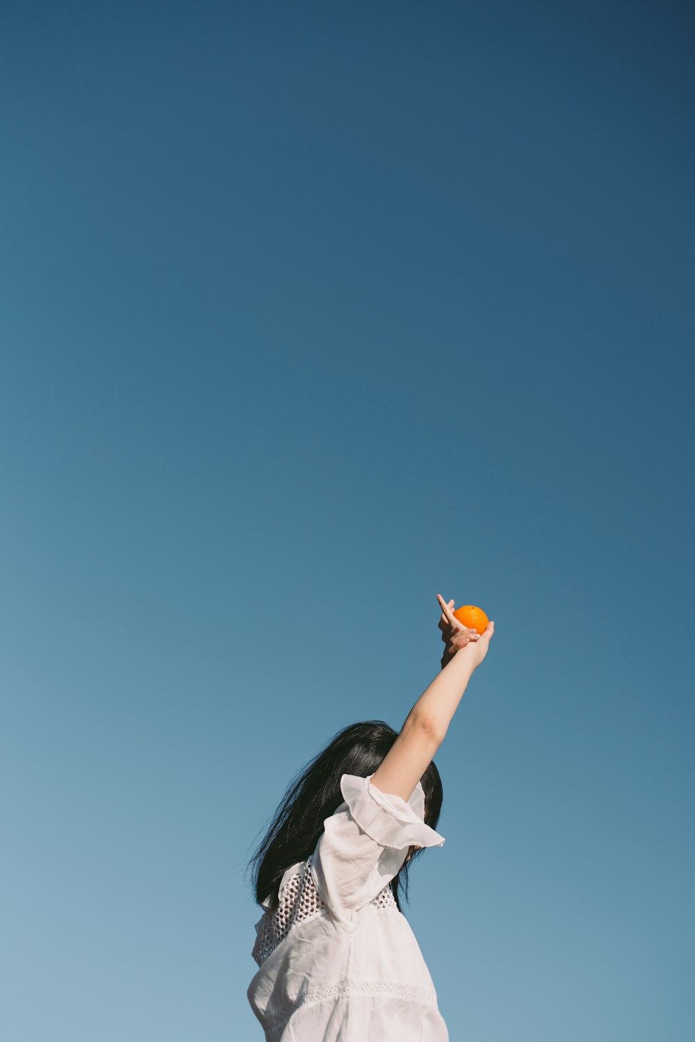 person holding orange fruit during daytime