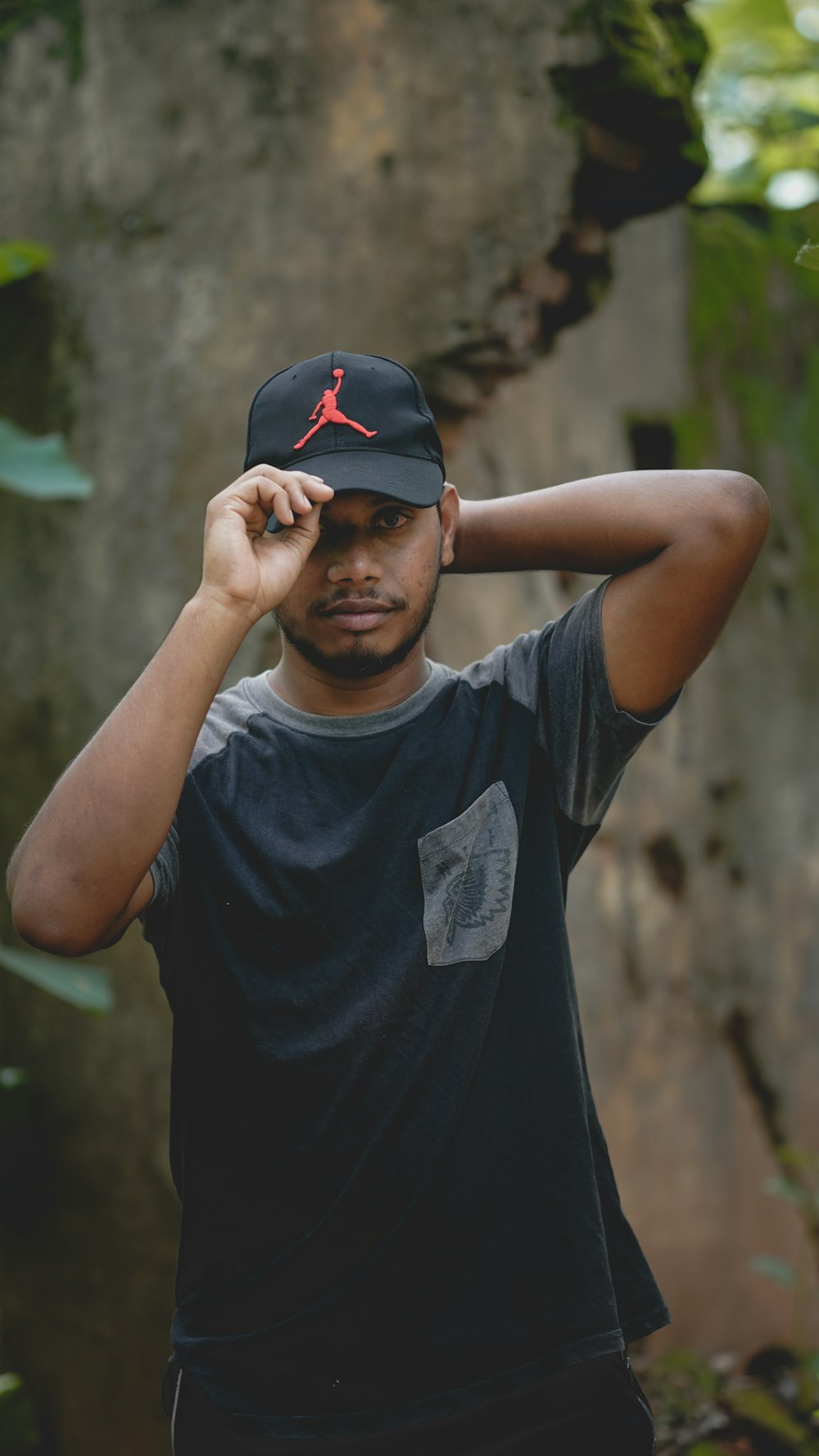 man in black and red nike cap and black crew neck t-shirt