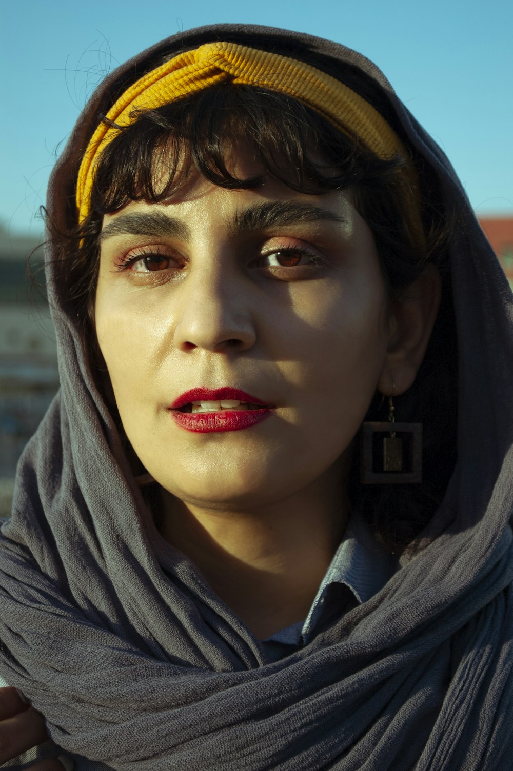 woman in gray scarf and red lipstick