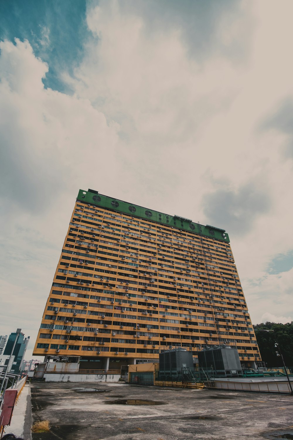 brown concrete building under white clouds during daytime