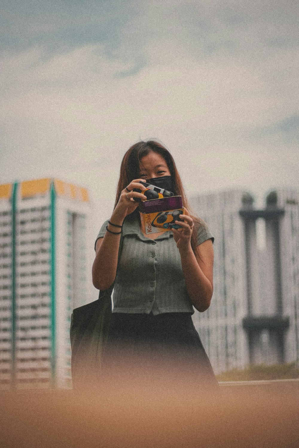 woman in black dress holding smartphone