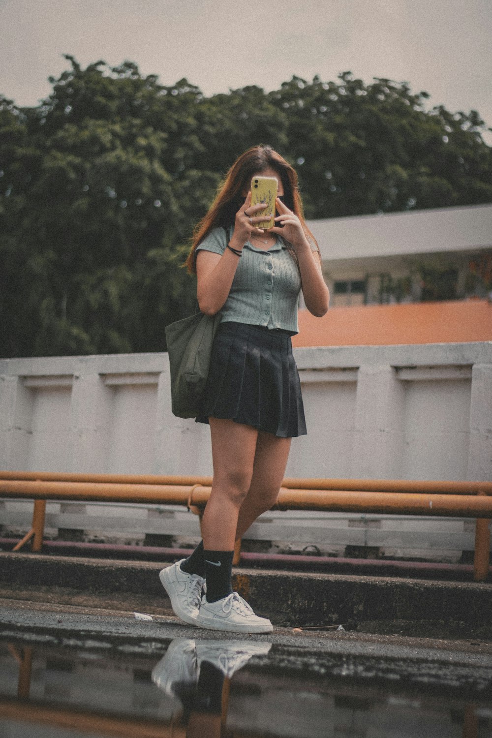 woman in gray and black dress wearing black and white nike sneakers