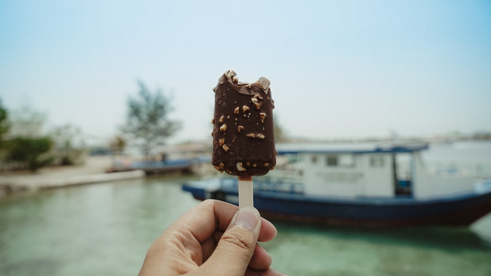 person holding chocolate ice cream