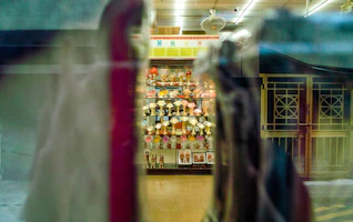 Colorful trophies and medals displayed on a wooden shelf with soft lighting