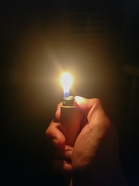 person holding lighter with light