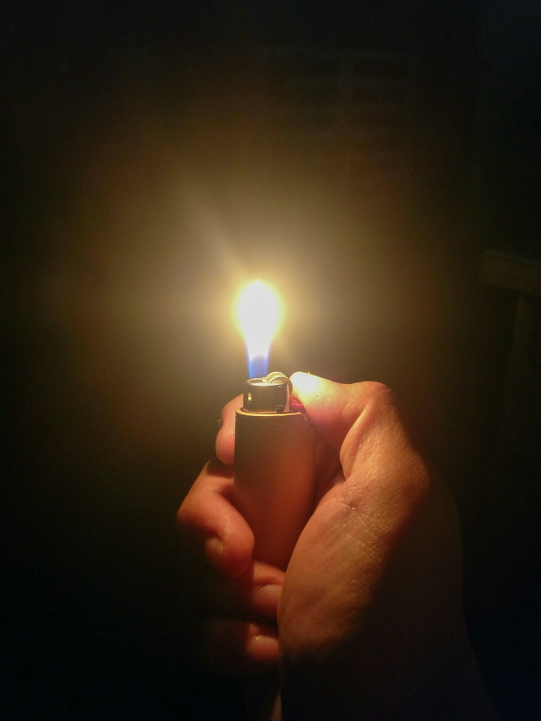 person holding lighter with light