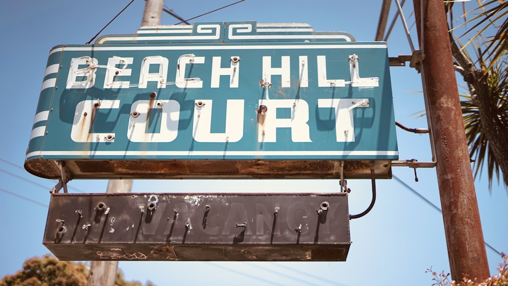 a sign that reads beach hill court hanging from a telephone pole