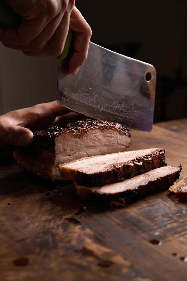 Sliced bread with cheese on brown wooden chopping board