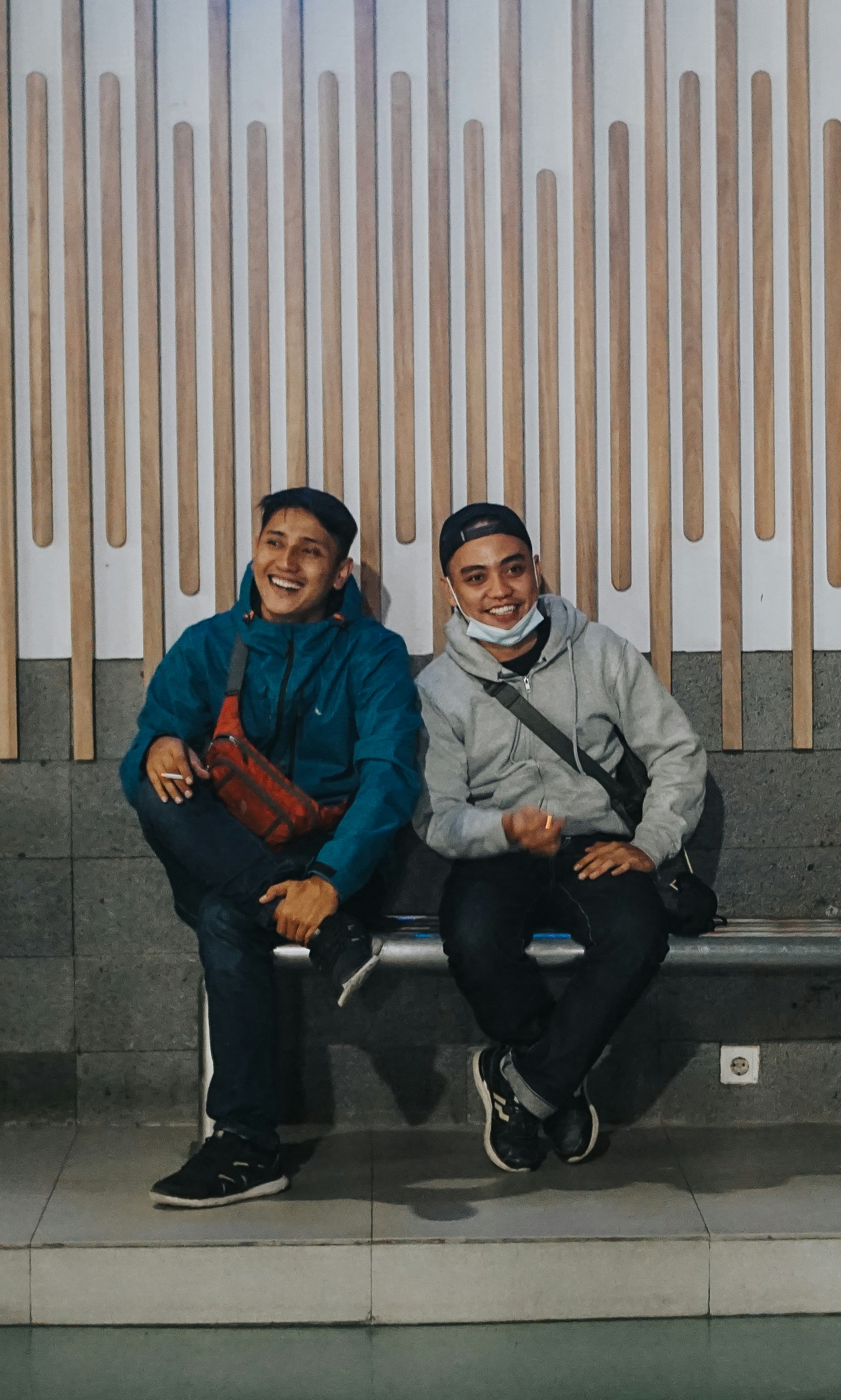 man in blue jacket sitting beside woman in gray jacket