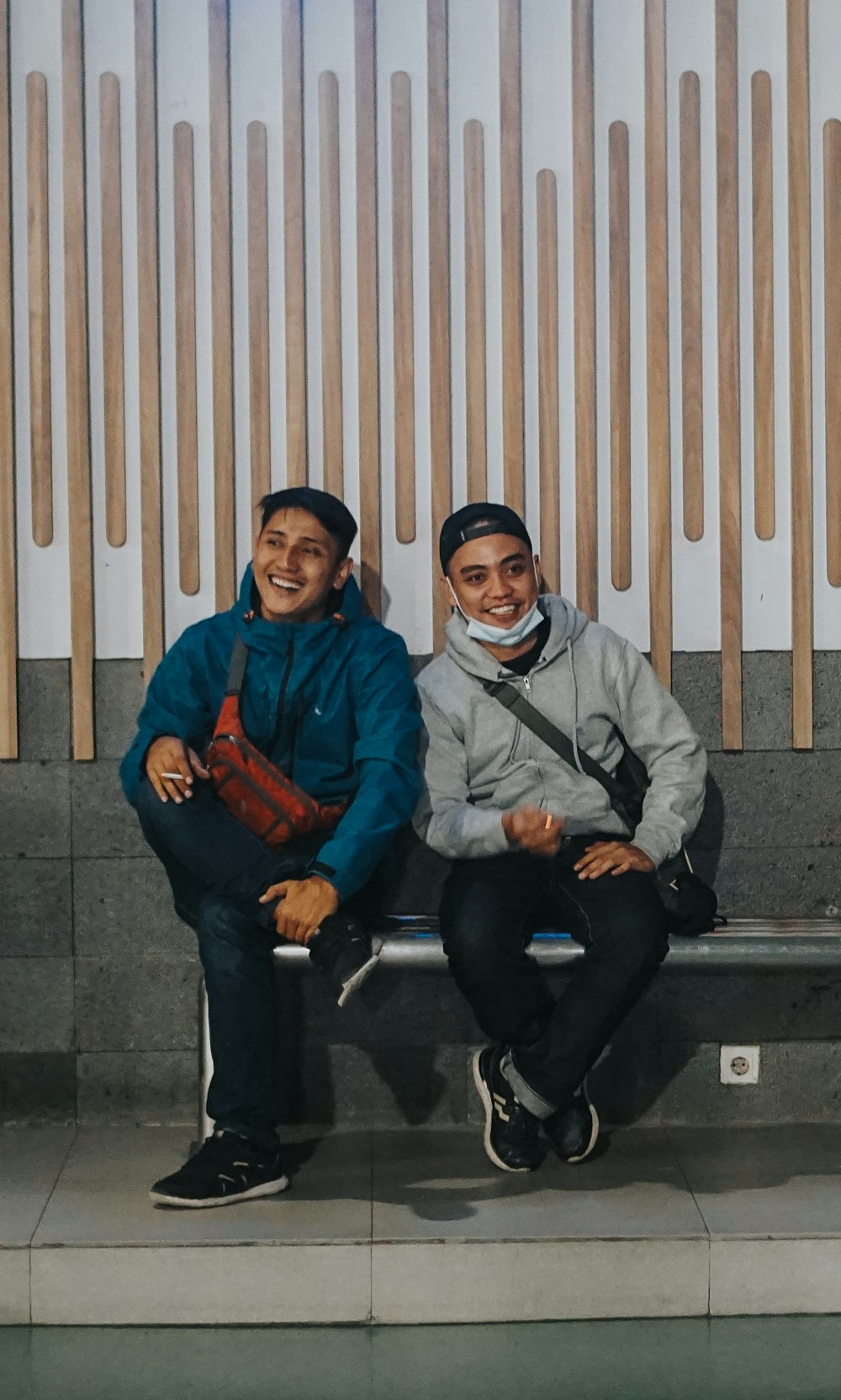 man in blue jacket sitting beside woman in gray jacket