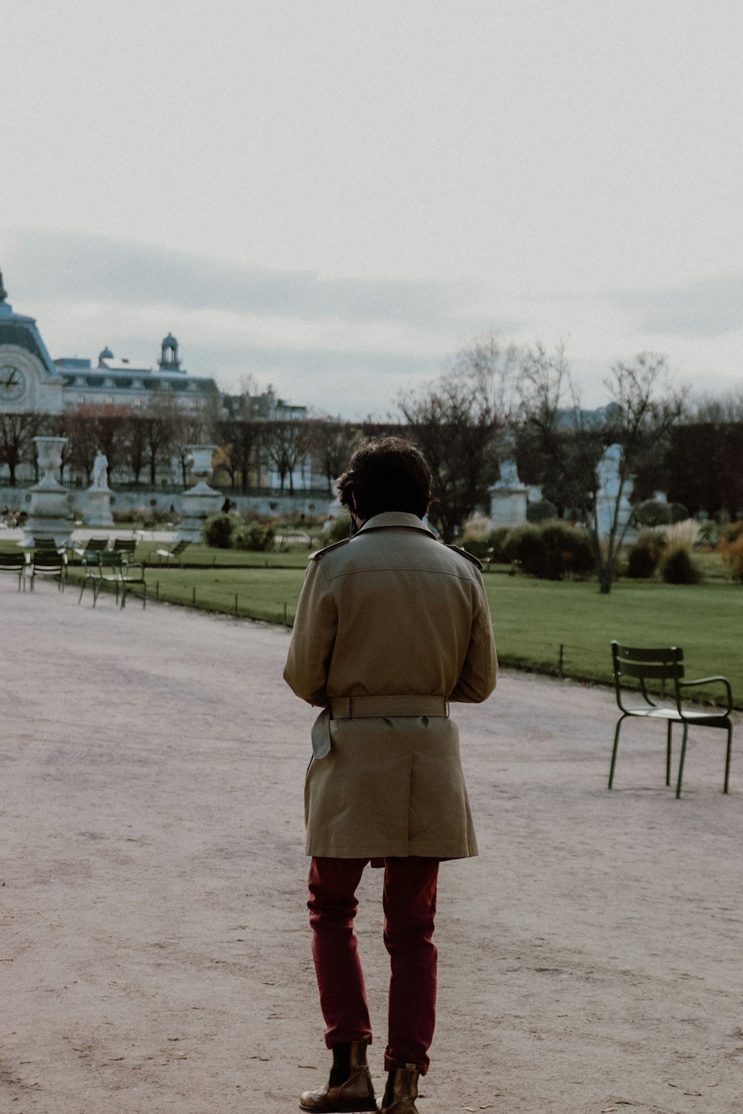 woman in brown coat standing on brown field during daytime