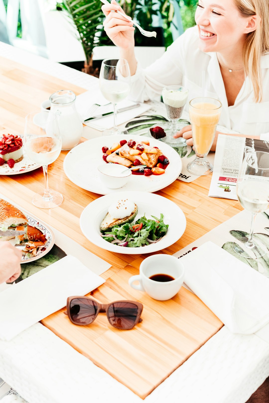 white ceramic plate with vegetable salad and wine glass on table