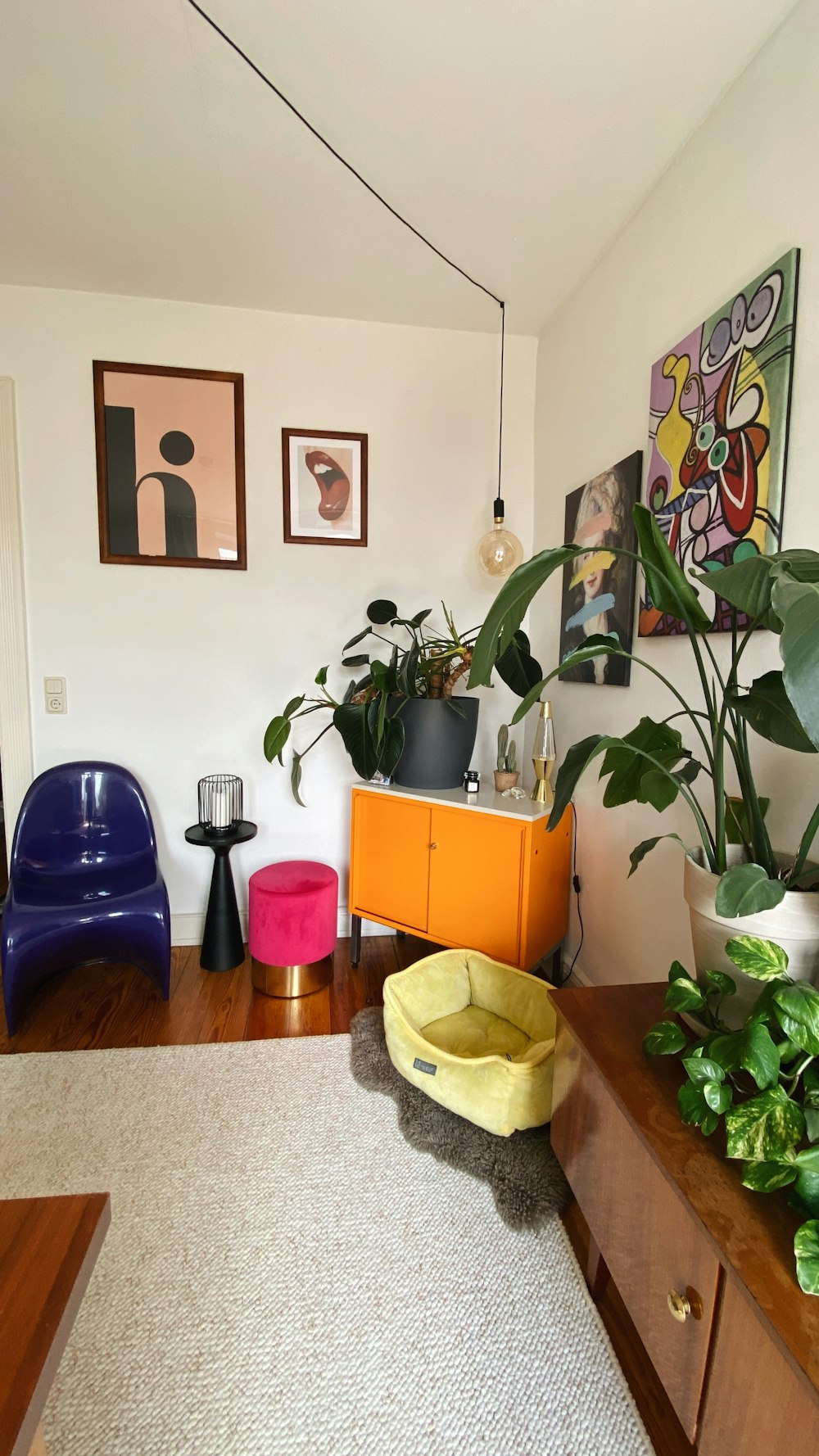 a living room with a lot of plants on the wall