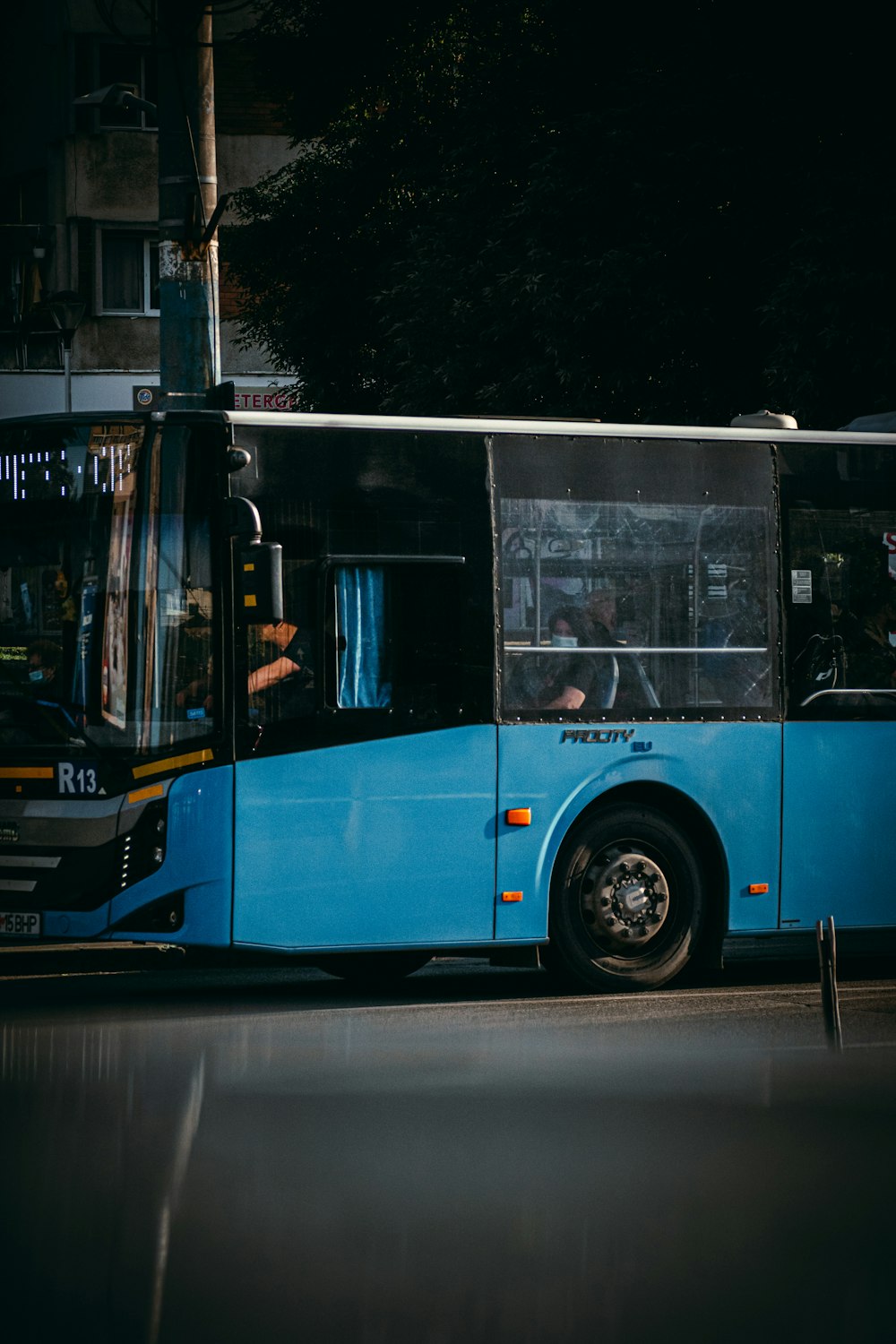 blue and brown bus on road during daytime