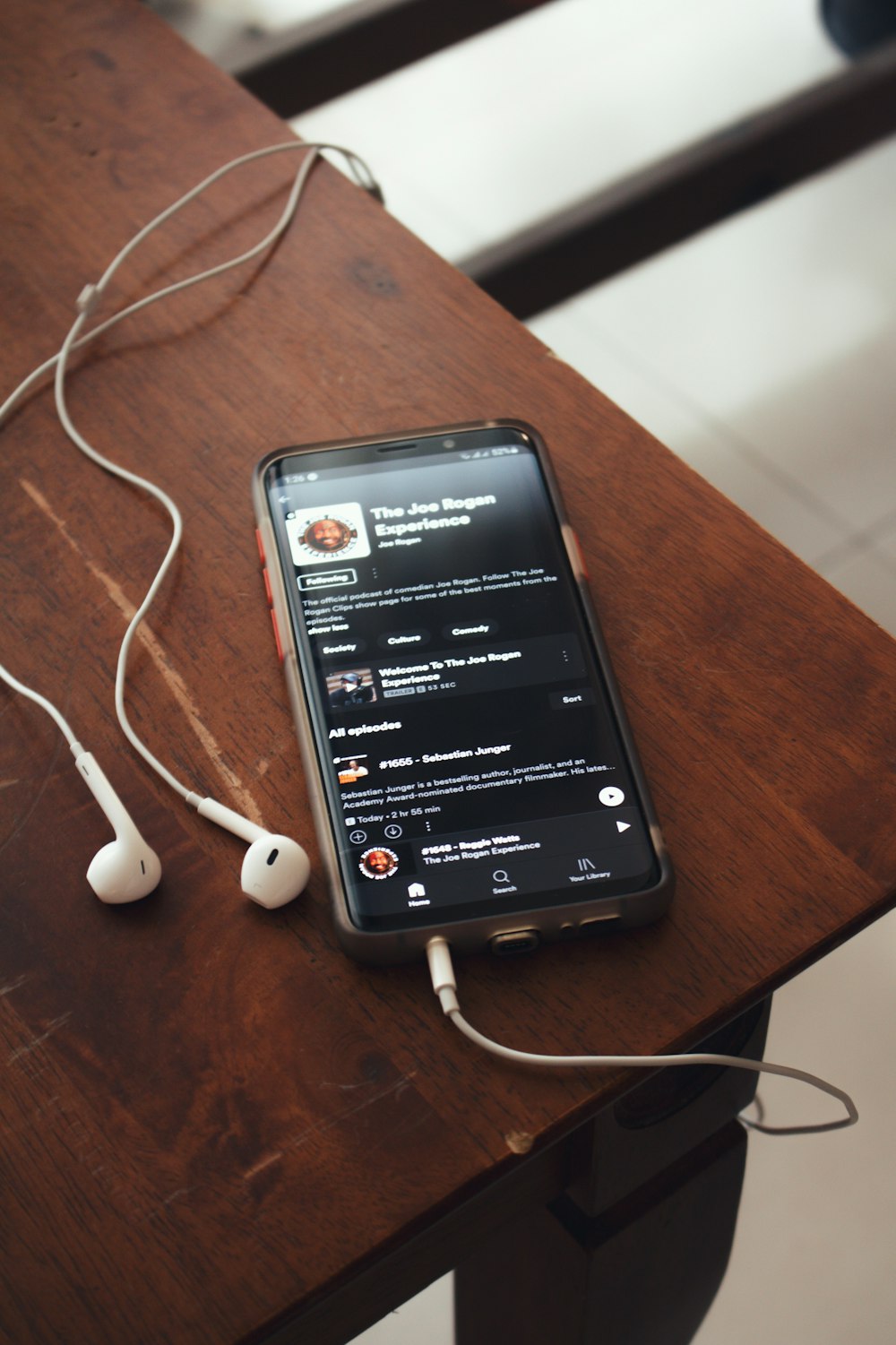 black samsung android smartphone on brown wooden table