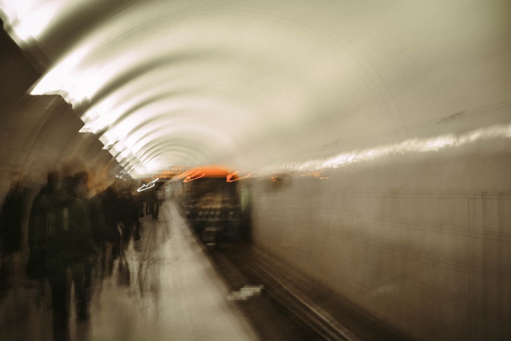 white and orange train on rail road