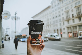 person holding black and red cup
