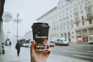 person holding black and red cup