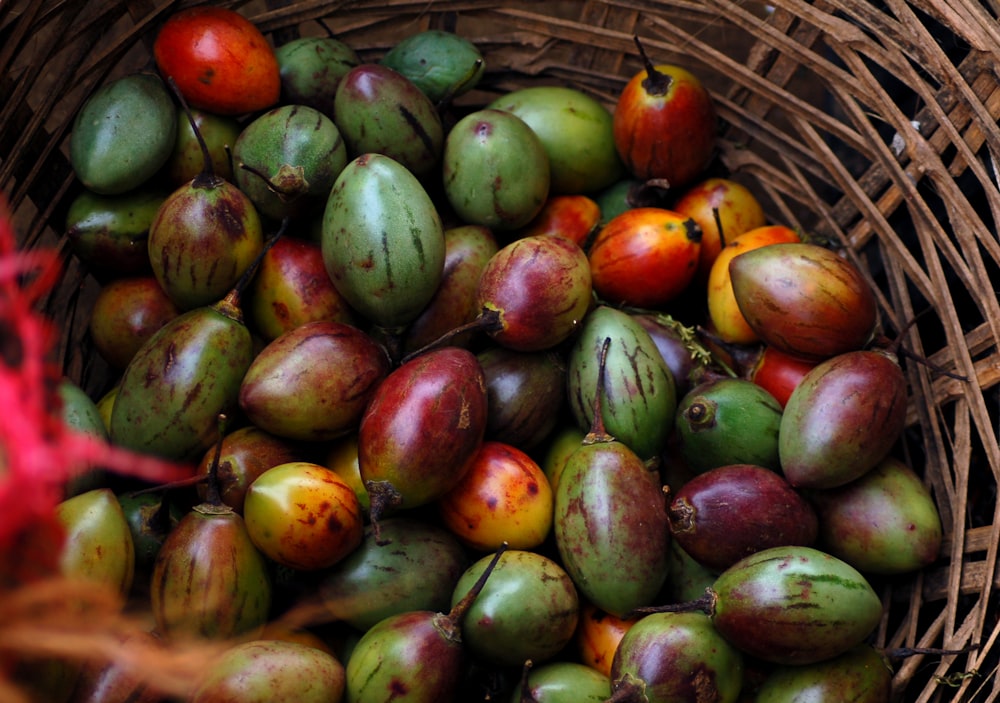 green and red apple fruit on brown woven basket