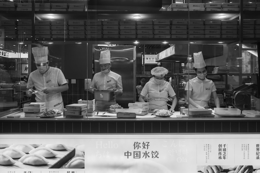 grayscale photo of people in kitchen