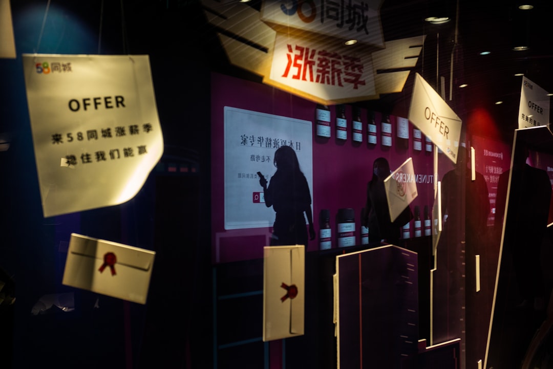 man in black jacket standing near store