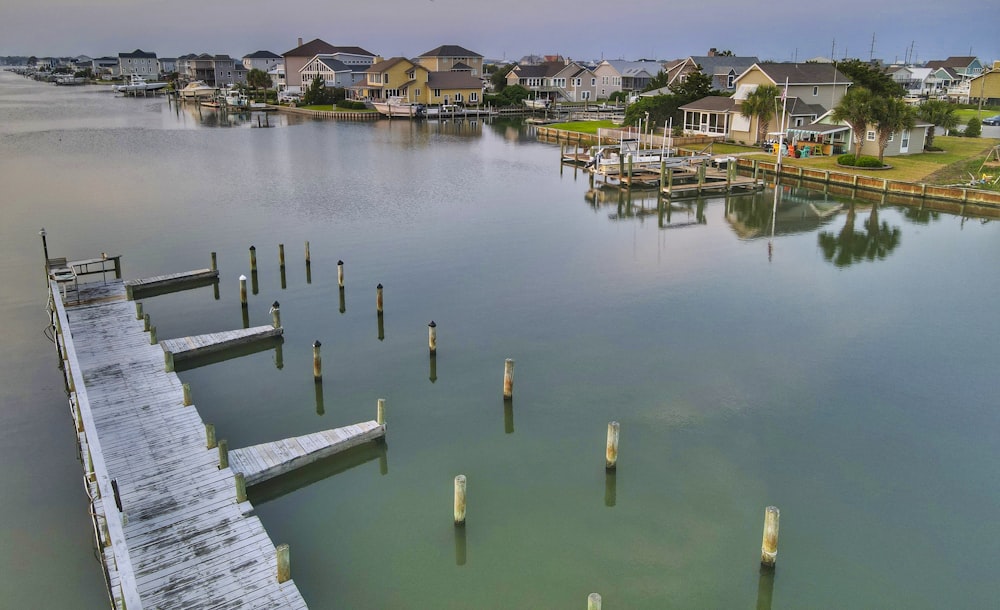 brown wooden dock on body of water during daytime