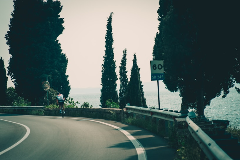 Cyclists riding along a scenic coastal road in Ibiza during the race.