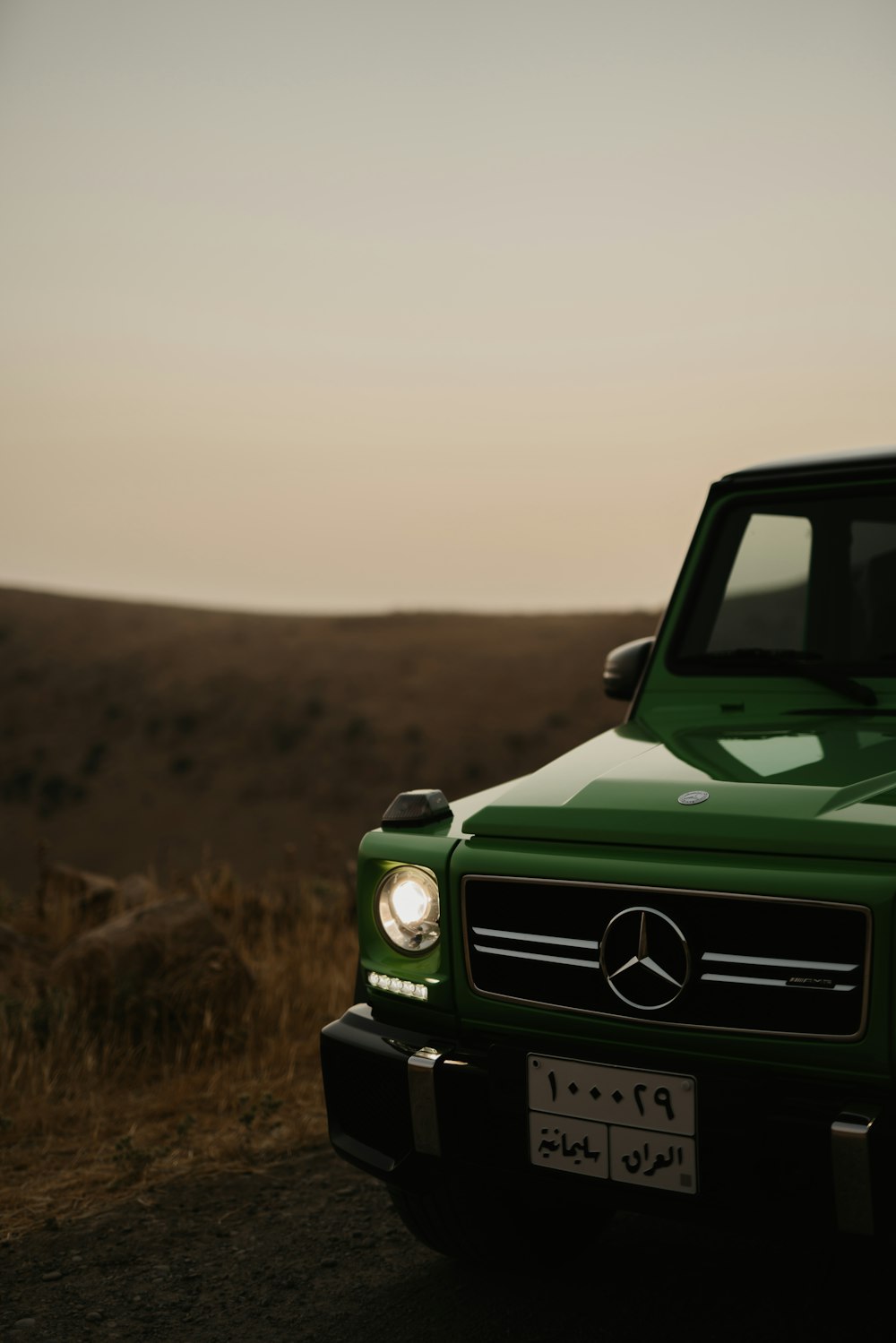 green jeep wrangler on brown field during daytime