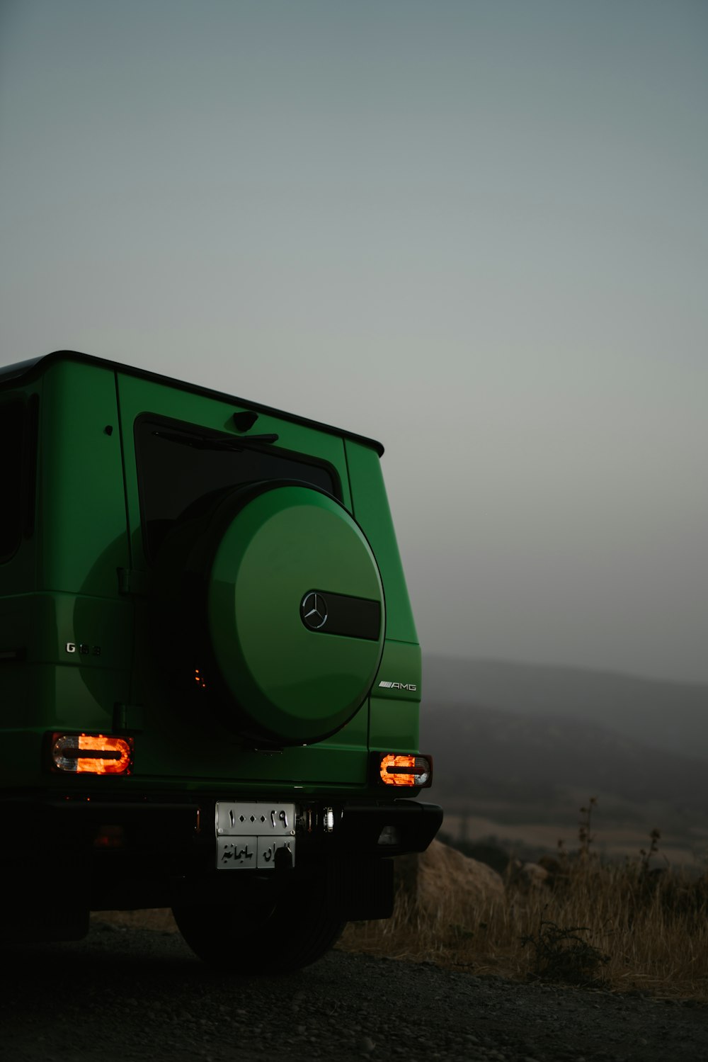 green and black truck on road during daytime