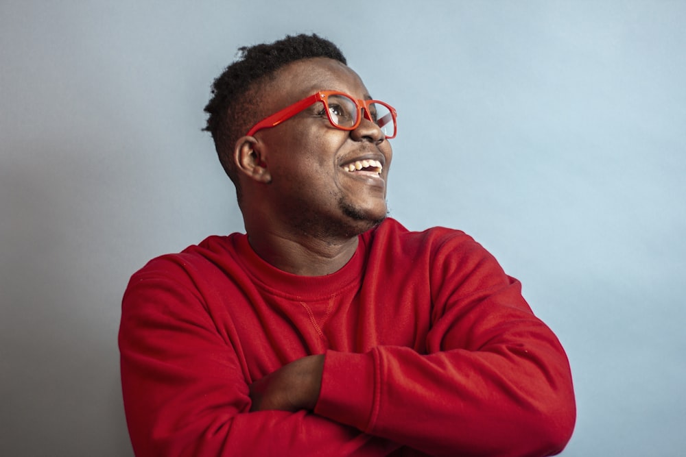 man in red sweater wearing black framed eyeglasses