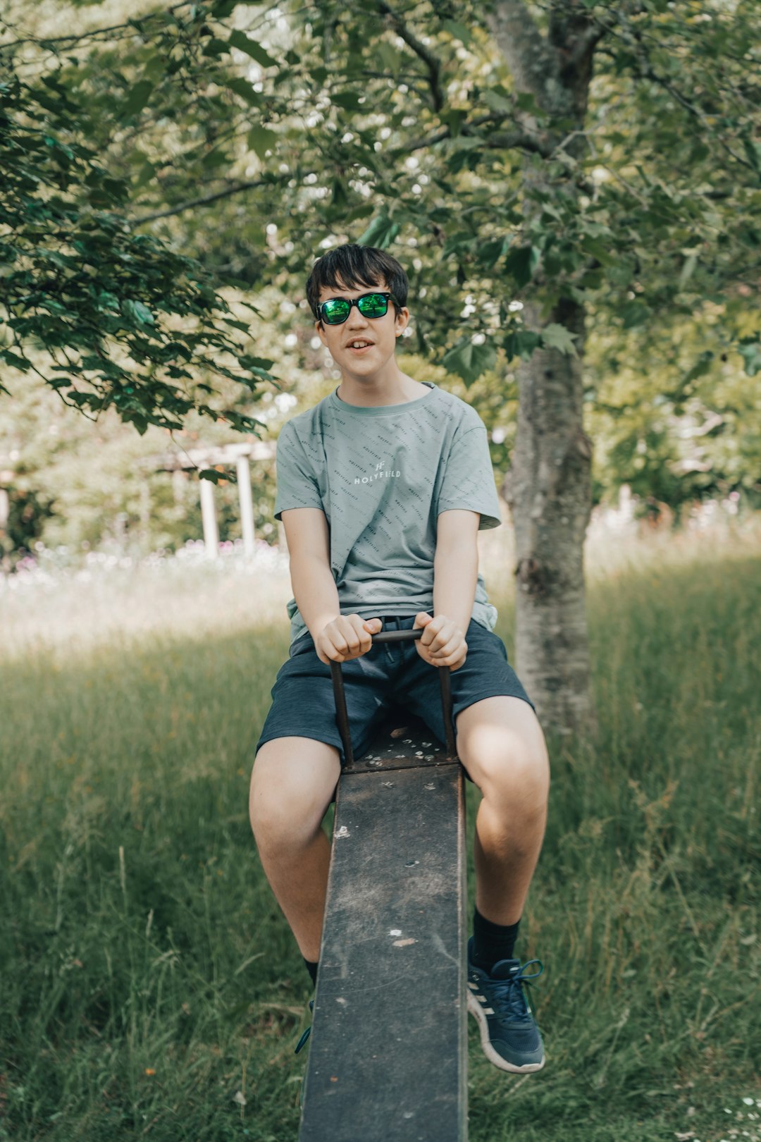 man in white crew neck t-shirt sitting on gray concrete bench during daytime