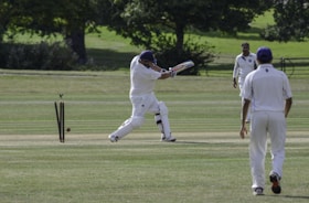 man in white shirt and pants playing golf during daytime