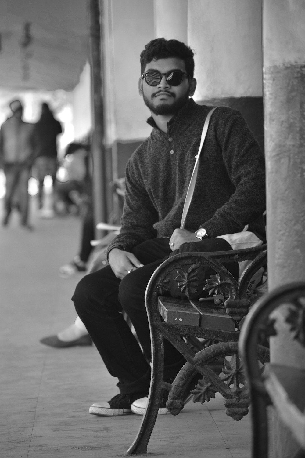 man in black jacket sitting on bench