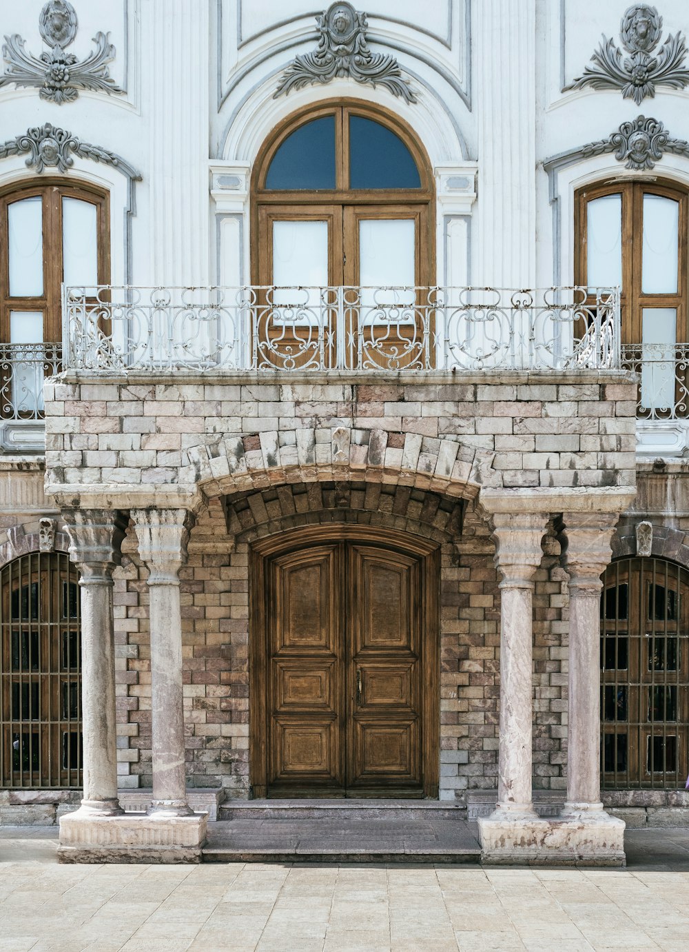 brown wooden door on white concrete building